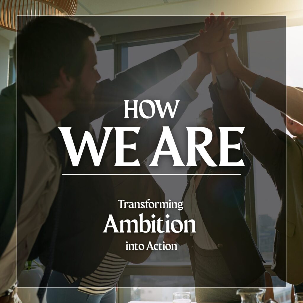 A team high-fives in an office setting with the message “Transforming Ambition into Action